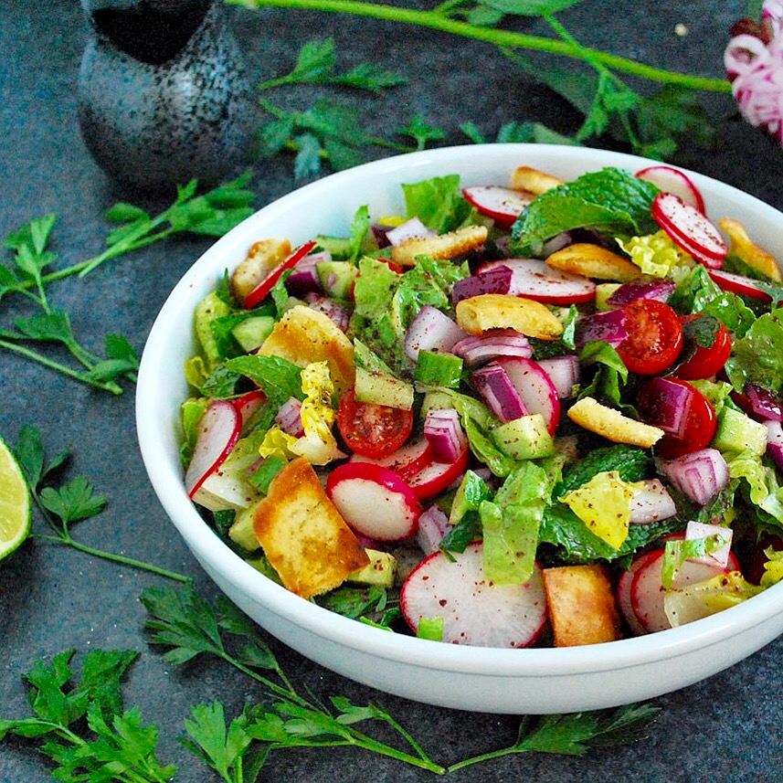 Fattoush is a vegan salad that is a staple on Middle Eastern dinner tables. Crunchy pita bread croutons, flavorful veggies and a tangy sumac dressing!