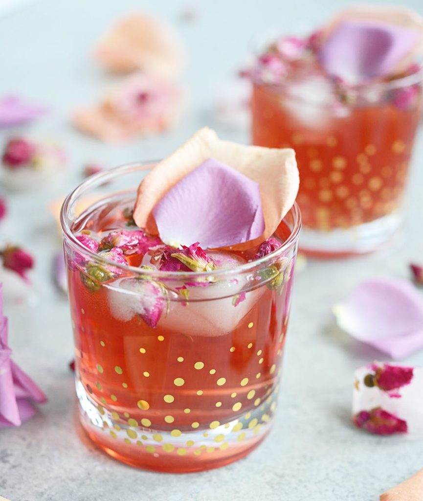 This Pomegranate Rose Gin Fizz is a gin-based cocktail with pomegranate juice, club soda and a splash of rosewater for a lovely pink, Persian-inspired drink.