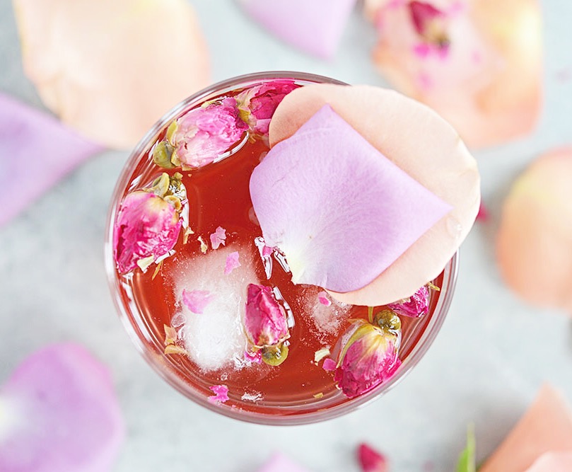 This Pomegranate Rose Gin Fizz is a gin-based cocktail with pomegranate juice, club soda and a splash of rosewater for a lovely pink, Persian-inspired drink.