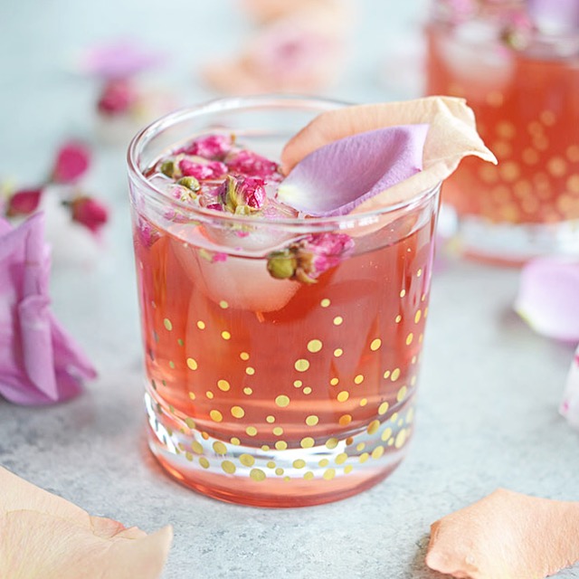 This Pomegranate Rose Gin Fizz is a gin-based cocktail with pomegranate juice, club soda and a splash of rosewater for a lovely pink, Persian-inspired drink.